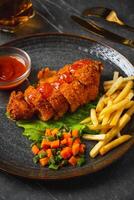 A chicken cordon bleu or schnitzel cordon bleu is a dish of meat wrapped around cheese, then breaded and pan-fried or deep fried. photo