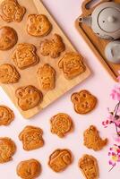 Mooncake biscuits are little sweet snacks which are like the outer layer of the mooncake. Unlike the traditional baked mooncakes, these biscuits are usually made without filling and are much thicker. photo