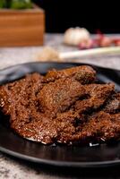 Beef Rendang is a Minang dish originating from the Minangkabau region in West Sumatra, Indonesia. Rendang has been slow cooked and braised in a coconut milk seasoned with a herb and spice mixture photo