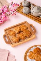Mooncake biscuits are little sweet snacks which are like the outer layer of the mooncake. Unlike the traditional baked mooncakes, these biscuits are usually made without filling and are much thicker. photo