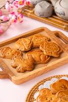 Mooncake biscuits are little sweet snacks which are like the outer layer of the mooncake. Unlike the traditional baked mooncakes, these biscuits are usually made without filling and are much thicker. photo