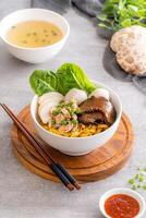 Bak chor mee. The noodles are tossed in vinegar, minced meat, pork slices, pork liver, stewed sliced mushrooms, meat balls and bits of deep-fried lard photo