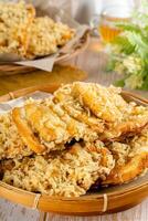 Pisang goreng Coklat Keju is a fritter made by deep frying battered plantain in hot oil. The batter most commonly uses a combination of flour, either wheat, rice flour, tapioca or bread crumb. photo