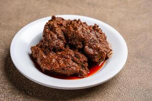 Beef Rendang is a Minang dish originating from the Minangkabau region in West Sumatra, Indonesia. photo