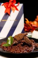 Beef Rendang is a Minang dish originating from the Minangkabau region in West Sumatra, Indonesia. Rendang has been slow cooked and braised in a coconut milk seasoned with a herb and spice mixture photo