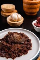 Beef Rendang is a Minang dish originating from the Minangkabau region in West Sumatra, Indonesia. Rendang has been slow cooked and braised in a coconut milk seasoned with a herb and spice mixture photo