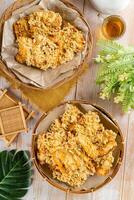 Pisang goreng Coklat Keju is a fritter made by deep frying battered plantain in hot oil. The batter most commonly uses a combination of flour, either wheat, rice flour, tapioca or bread crumb. photo