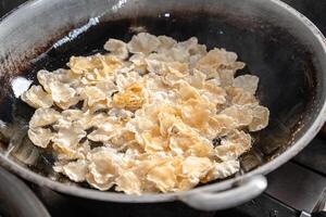 making process Emping Balado, Spicy Snacks from West Sumatra. Made from melinjo crackers, it's crunchy and sweet and spicy. photo