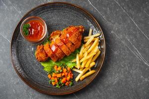 A chicken cordon bleu or schnitzel cordon bleu is a dish of meat wrapped around cheese, then breaded and pan-fried or deep fried. photo