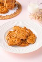 Mooncake biscuits are little sweet snacks which are like the outer layer of the mooncake. Unlike the traditional baked mooncakes, these biscuits are usually made without filling and are much thicker. photo