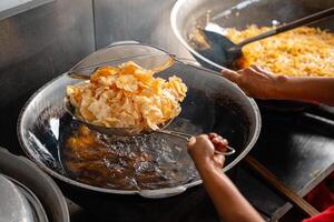 making process Emping Balado, Spicy Snacks from West Sumatra. Made from melinjo crackers, it's crunchy and sweet and spicy. photo