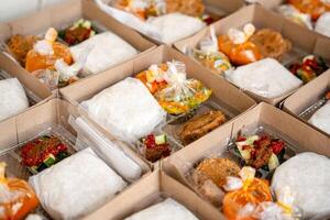 In Indonesian it is called Rice Box or Nasi kotak with perkedel kentang. Usually distributed during celebrations or catering packaging. photo