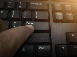 The finger push on the Enter key on the keyboard , Aprove data concept. photo