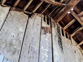 features a rustic wooden ceiling with exposed beams and aged planks photo