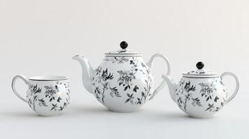 A refined black and white tea set featuring intricate floral patterns, including a teapot, creamer, and cup, displayed on a minimal background. photo