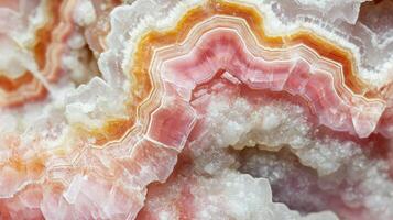 Polished rhodochrosite crystal highlighted in a macro shot, capturing its vivid pink hues. photo