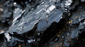 Polished tektite with a dark, glossy finish, displayed in a close-up shot that emphasizes its natural texture and reflective properties. photo