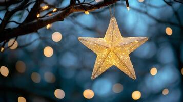 A glowing star-shaped ornament hangs on a tree branch, surrounded by soft bokeh lights, creating a peaceful winter scene. photo