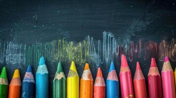 A Row Of Colorful Pencils On A Chalkboard photo