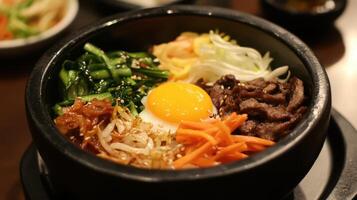 Tasty bibimbap bowl topped with an egg. photo