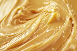 Creamy peanut butter spread swirled in a bowl photo
