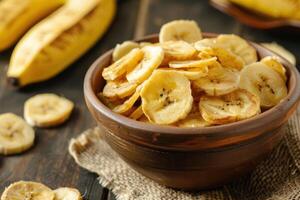 Tasty dried banana chips in the bowl photo