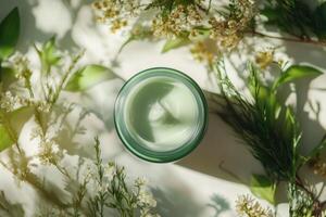 Natural green cream surrounded by fresh greenery and blooms photo