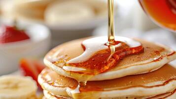 A Golden Syrup Waterfall Descends Upon Fluffy Pancakes photo