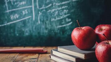 Classroom environment with apples, books, and chalkboard supplies. photo