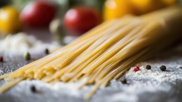 Detailed view of raw spaghetti surrounded by flour and pepper. photo