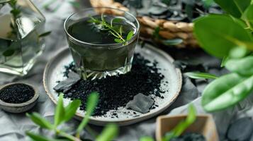 A Glass of Activated Charcoal Water Surrounded by Nature's Elements photo