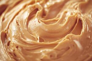 Creamy peanut butter swirls in a bowl during preparation photo
