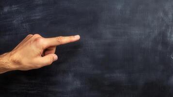 Educator pointing at a blank blackboard with a symbolic gesture. photo