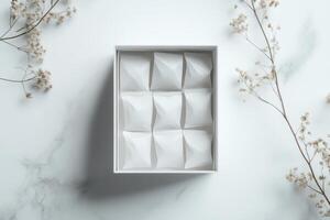 Elegant white box with unique patterned lid on marble surface photo