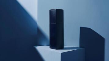 A Single Bottle of Perfume Casts a Shadow in a Blue Room photo