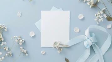 A Blank Canvas of Blue With Delicate White Blooms and a Ribbon Bow photo