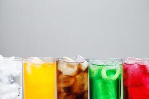 Soft drinks and fruit juice mixed with soda high in sugar have a negative effect on physical health photo