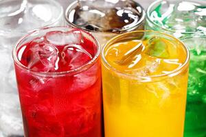 Soft drinks and fruit juice mixed with soda high in sugar have a negative effect on physical health photo