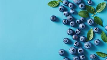 A Scattering of Blueberries on a Bright Blue Background photo
