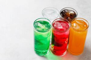 Soft drinks and fruit juice mixed with soda high in sugar have a negative effect on physical health photo