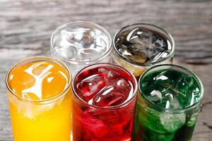 Soft drinks and fruit juice mixed with soda high in sugar have a negative effect on physical health photo