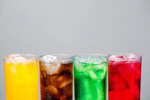 Soft drinks and fruit juice mixed with soda high in sugar have a negative effect on physical health photo