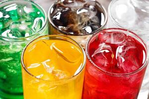 Soft drinks and fruit juice mixed with soda high in sugar have a negative effect on physical health photo