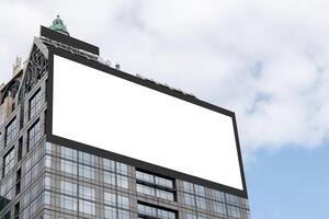 Mock up white LED display billboard on tower building with blue sky background .clipping path for mockup photo