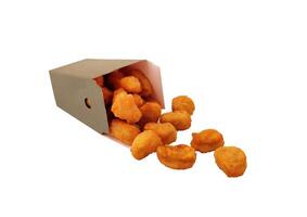 Crunchy chicken popcorn bites in carton container for fast food meals isolated on white background photo