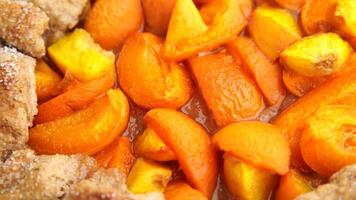 galette tart pie with fresh ripe apricot on a wooden board spins in a circle on all sides video