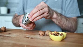 hands of a man cracking walnuts with a nutcracker video