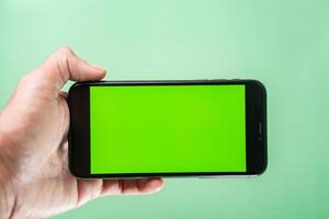 Smart phone with Green Screen in Hand photo