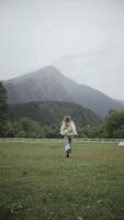Woman Running in Open Field with Mountain View in the Background video