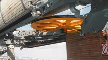 Large, circular, revolving yellow component of the funicular system that enables the cable to move and transport passengers. Close up. video